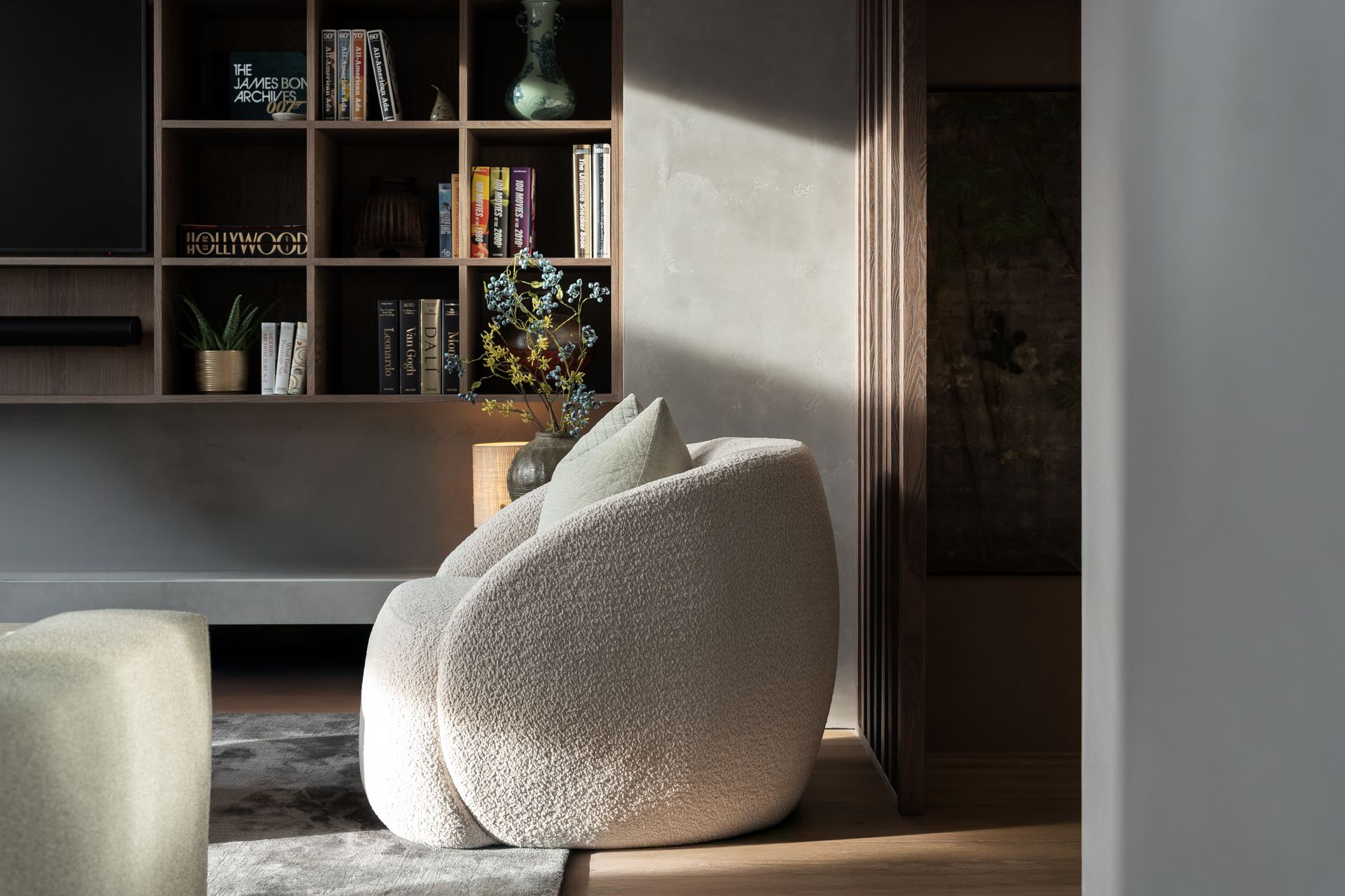 Chalet Escapade A living room with a chair and a bookshelf.
