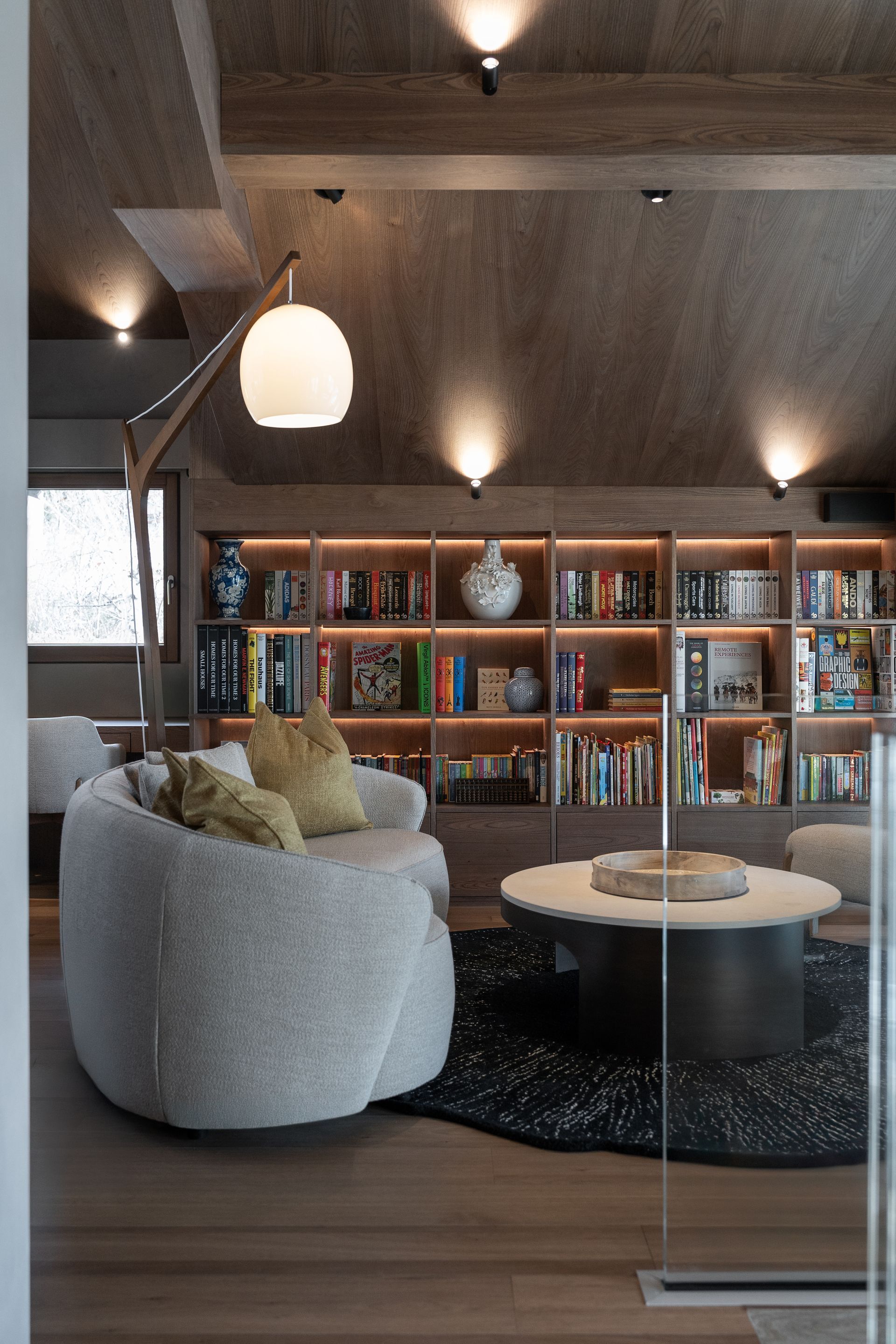 Chalet Escapade A living room with a chair , table , and bookshelf.