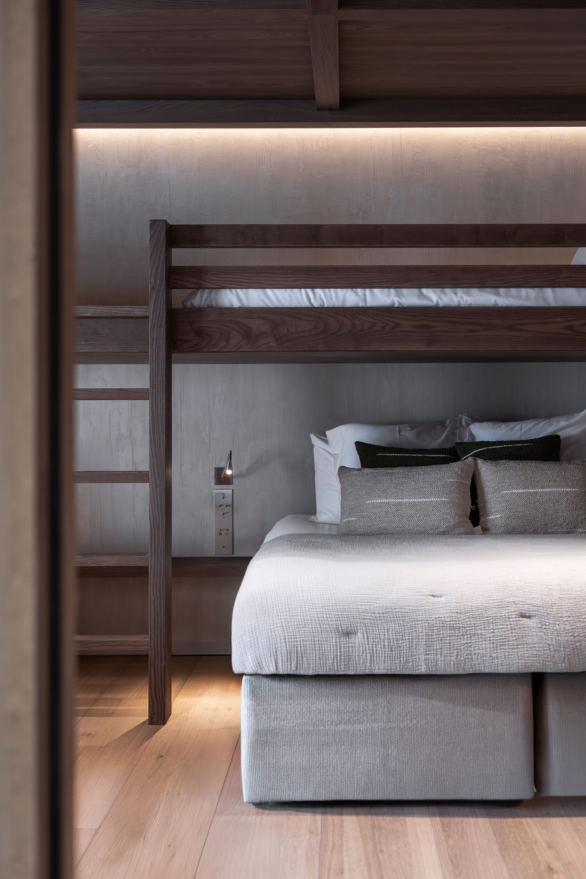 Chalet Escapade A bedroom with a bunk bed and a bed underneath it.