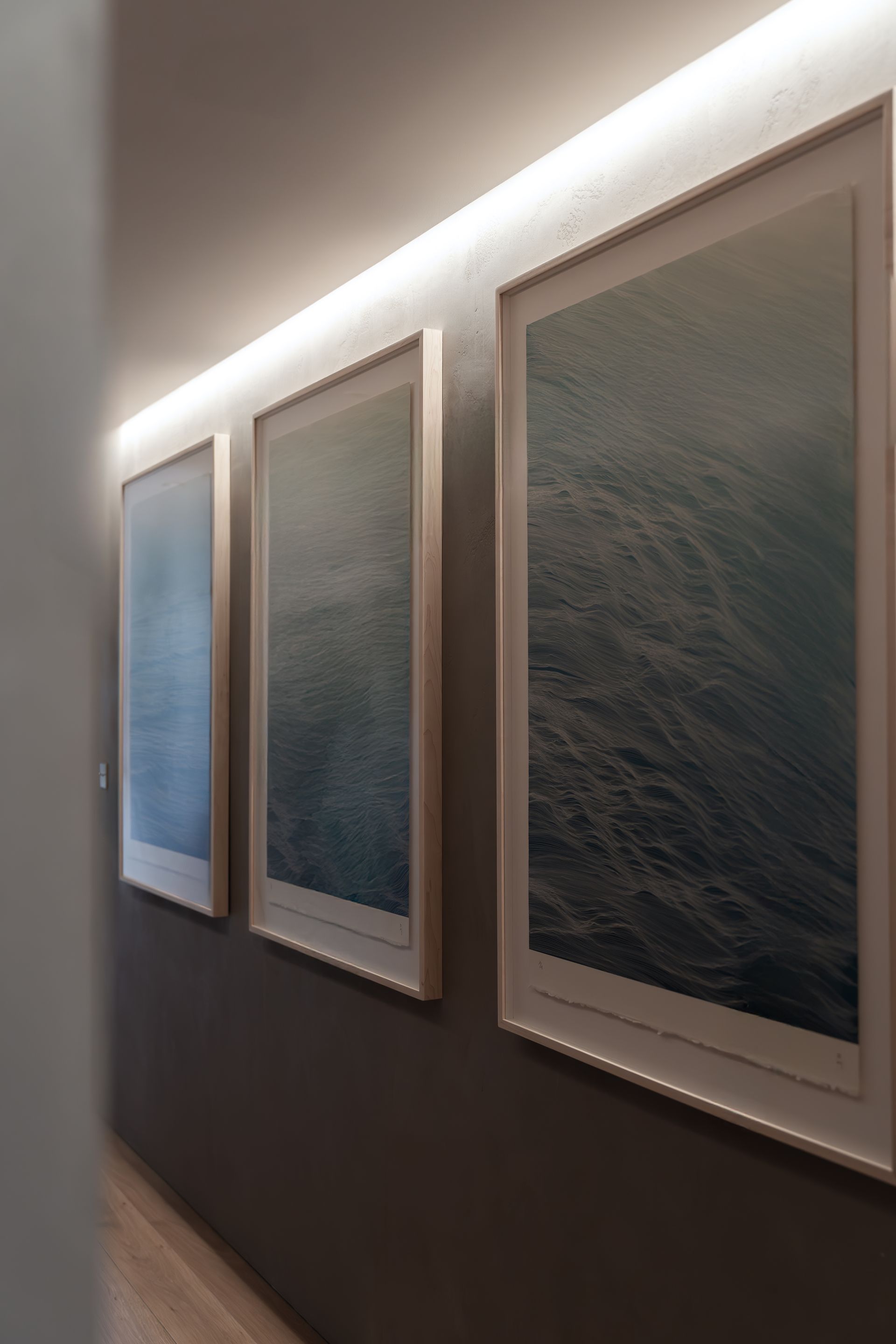 Chalet Escapade Three framed pictures are hanging on a wall in a hallway.