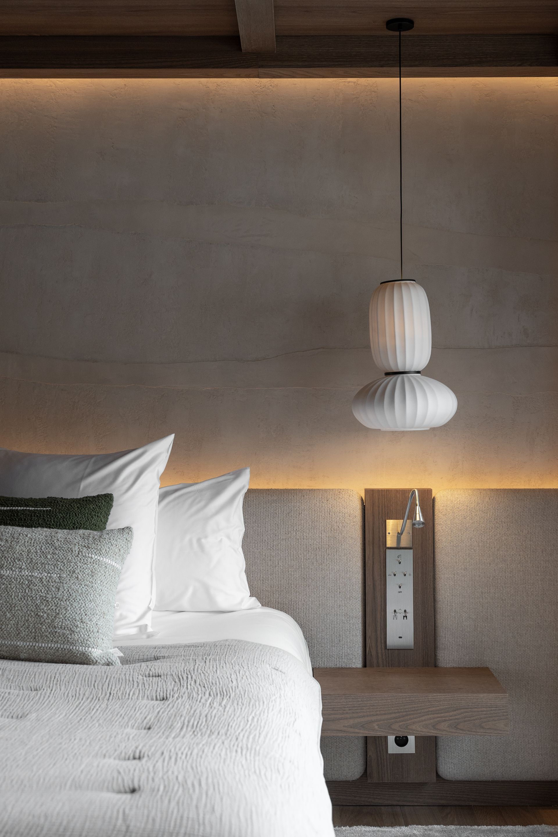 Chalet Escapade A bedroom with a bed , nightstand , and lamp hanging from the ceiling.