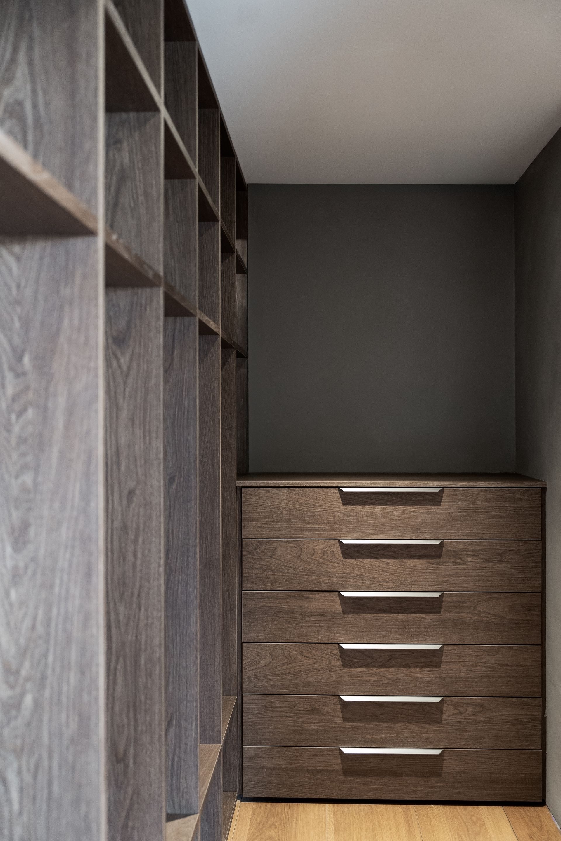 Chalet Escapade A walk in closet with wooden shelves and drawers.