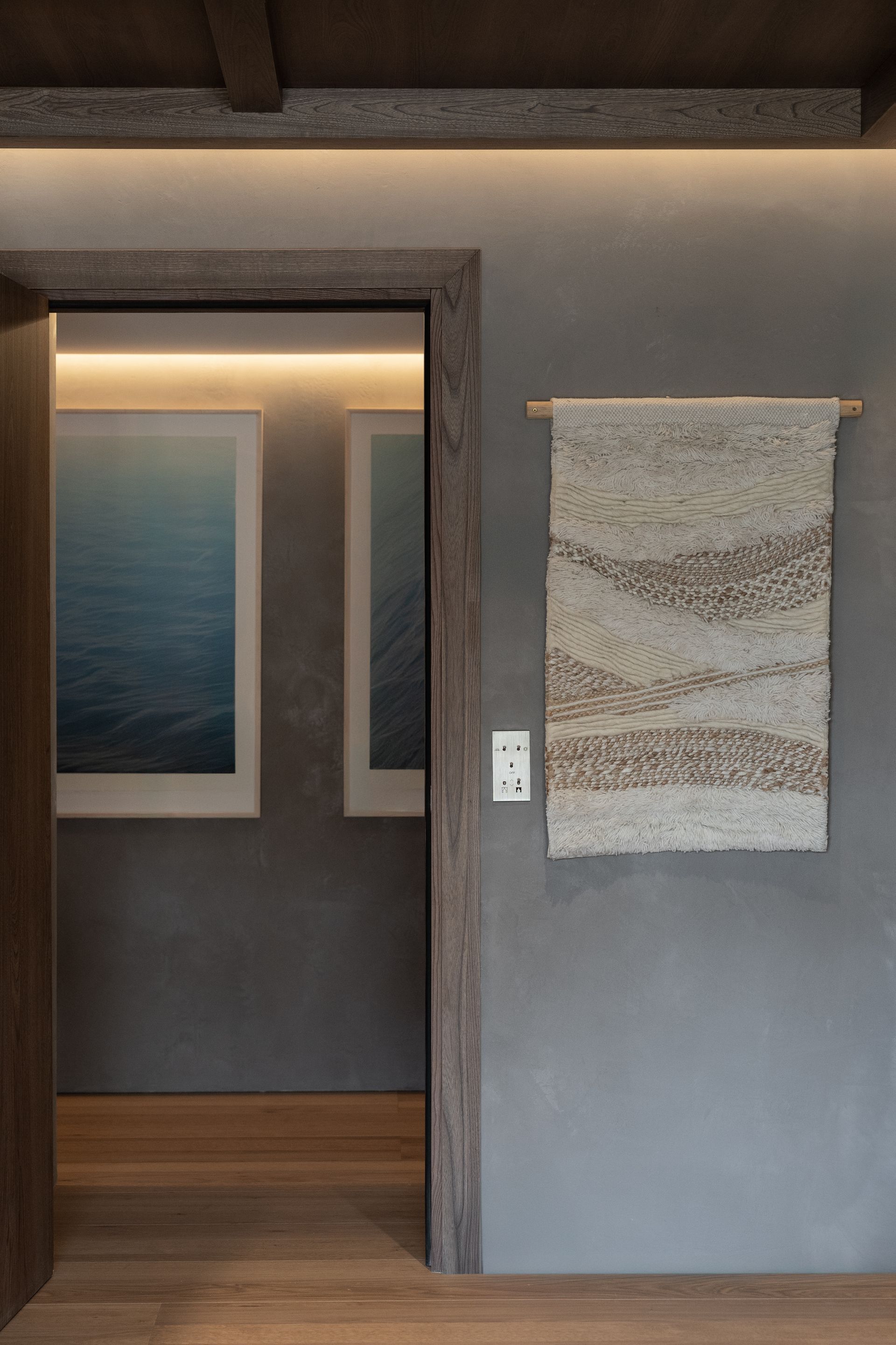 Chalet Escapade A room with a rug hanging on the wall and paintings on the wall.