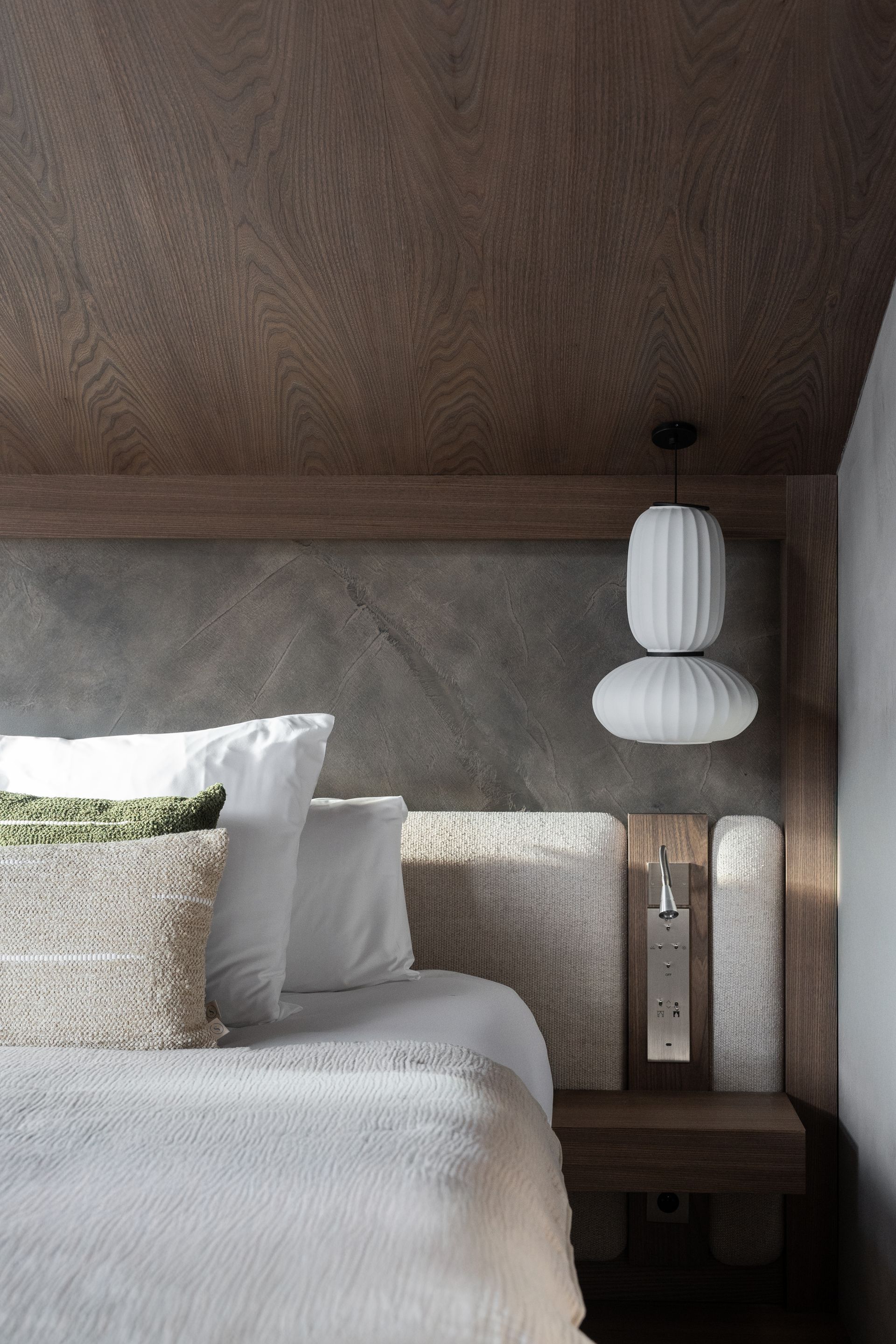 Chalet Escapade A bedroom with a bed , nightstand , and lanterns hanging from the ceiling.