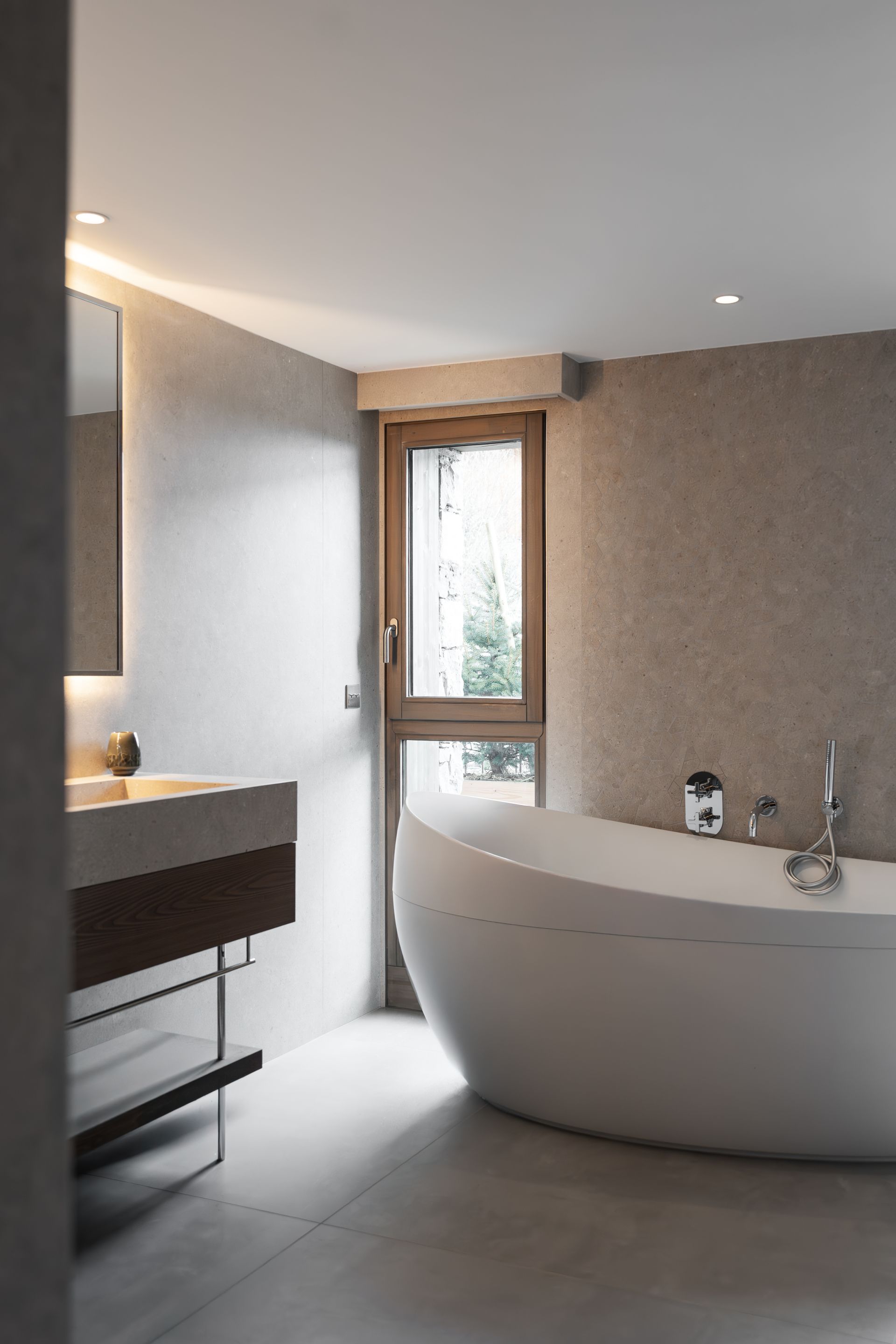 Chalet Escapade A bathroom with a tub , sink , mirror and window.