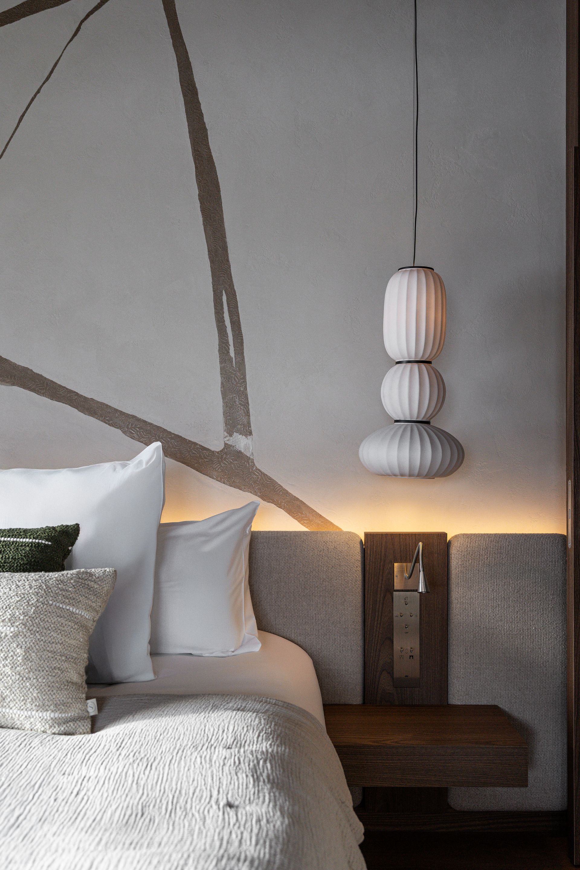 Chalet Escapade A bedroom with a bed , nightstand , and lanterns hanging from the ceiling.