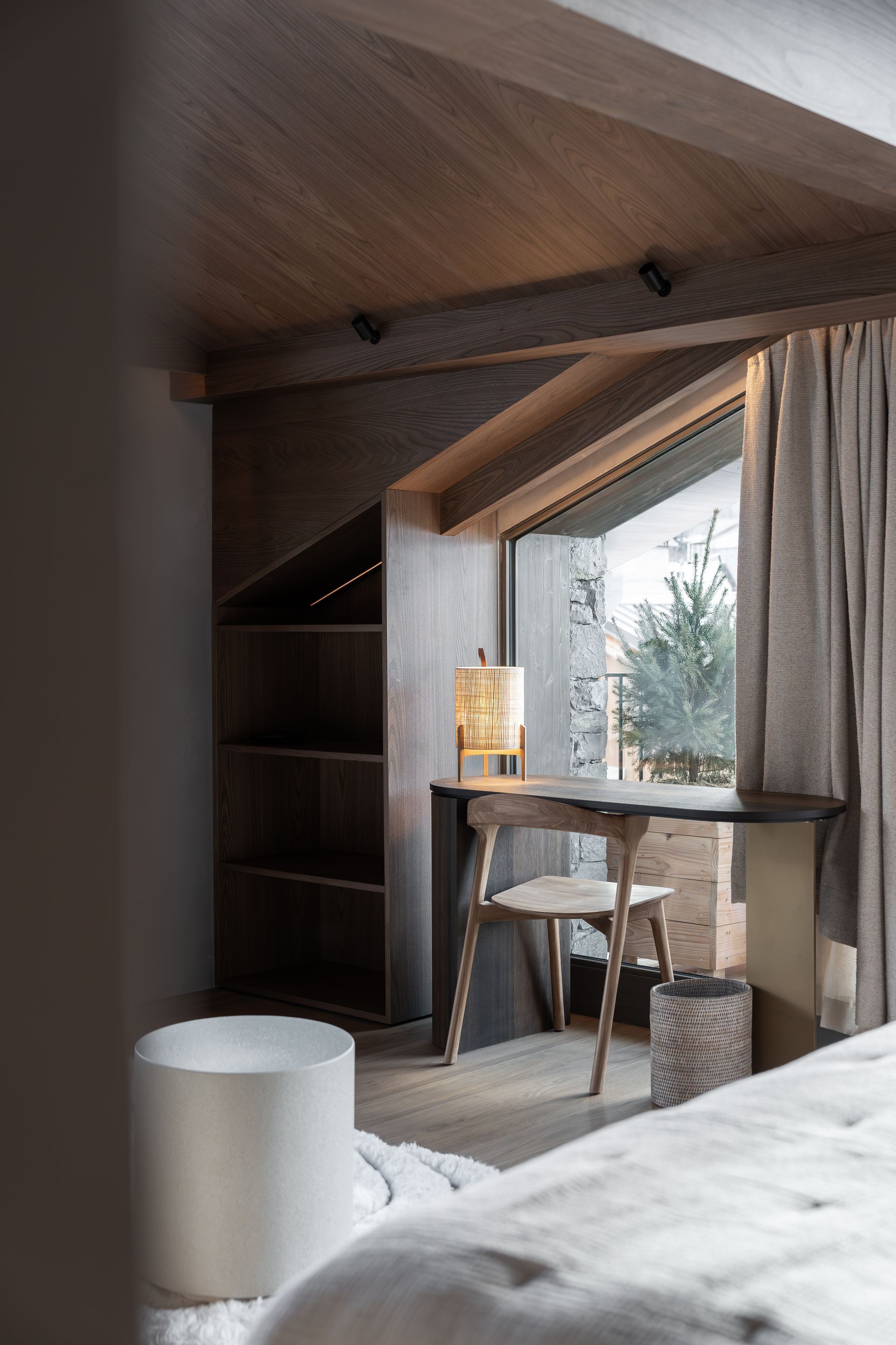 Chalet Escapade A bedroom with a desk and chair in front of a window.