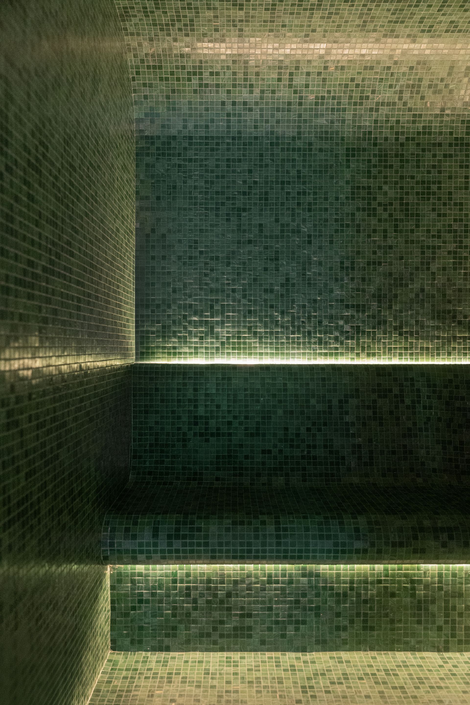 Chalet Escapade A room with green tiles on the walls and a bench in it.