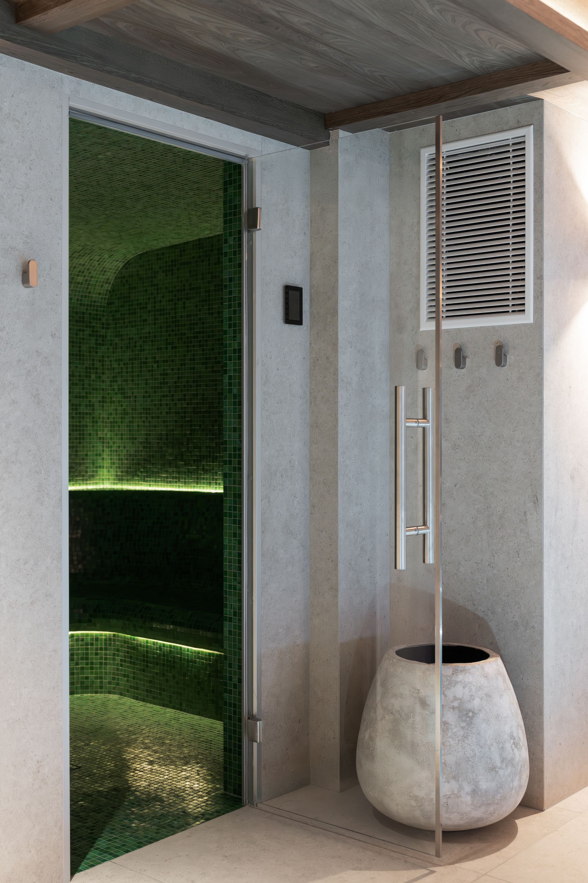 Chalet Escapade A room with a green door and a pot on the floor.