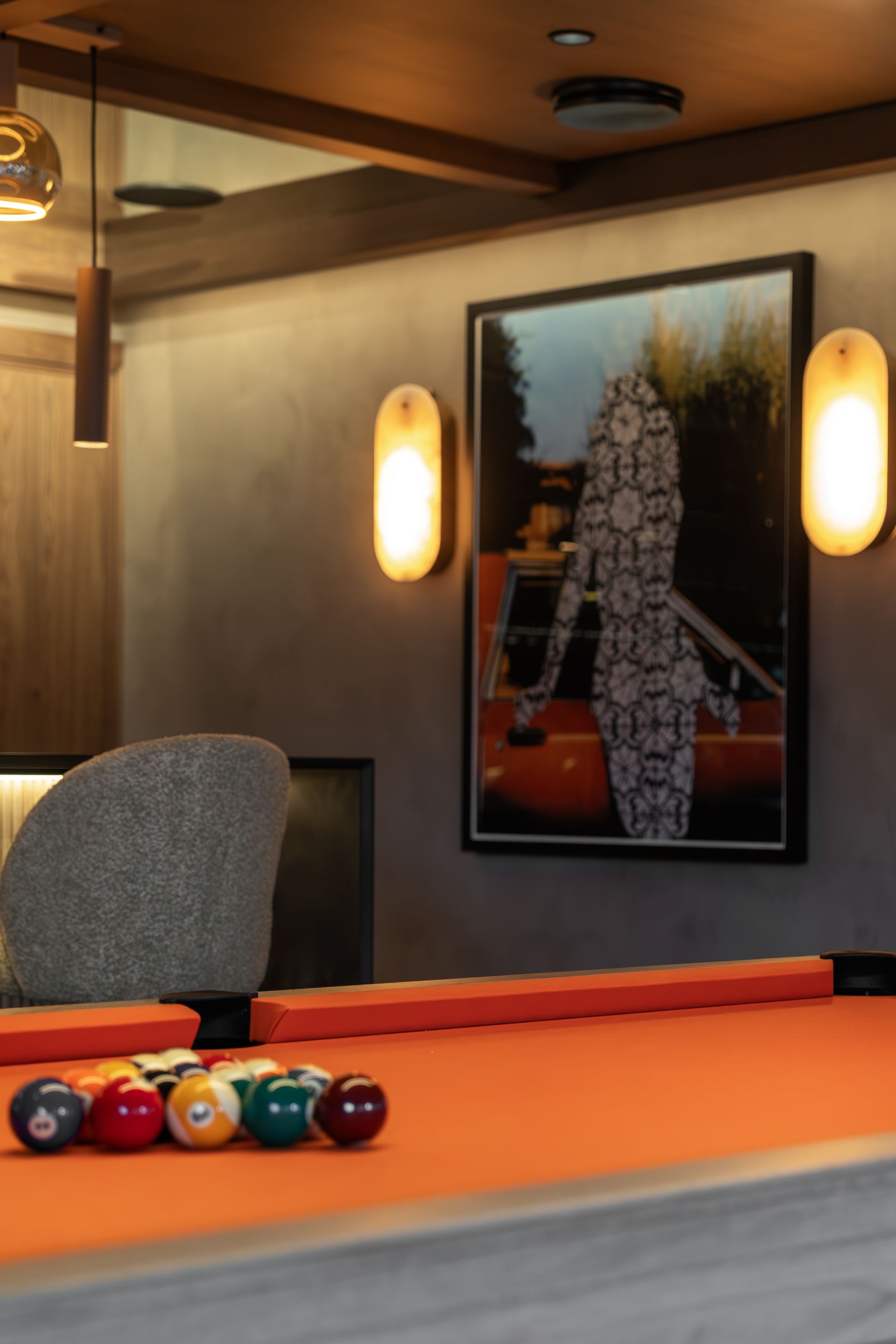 Chalet Escapade A pool table with pool balls on it in a room with a picture on the wall.
