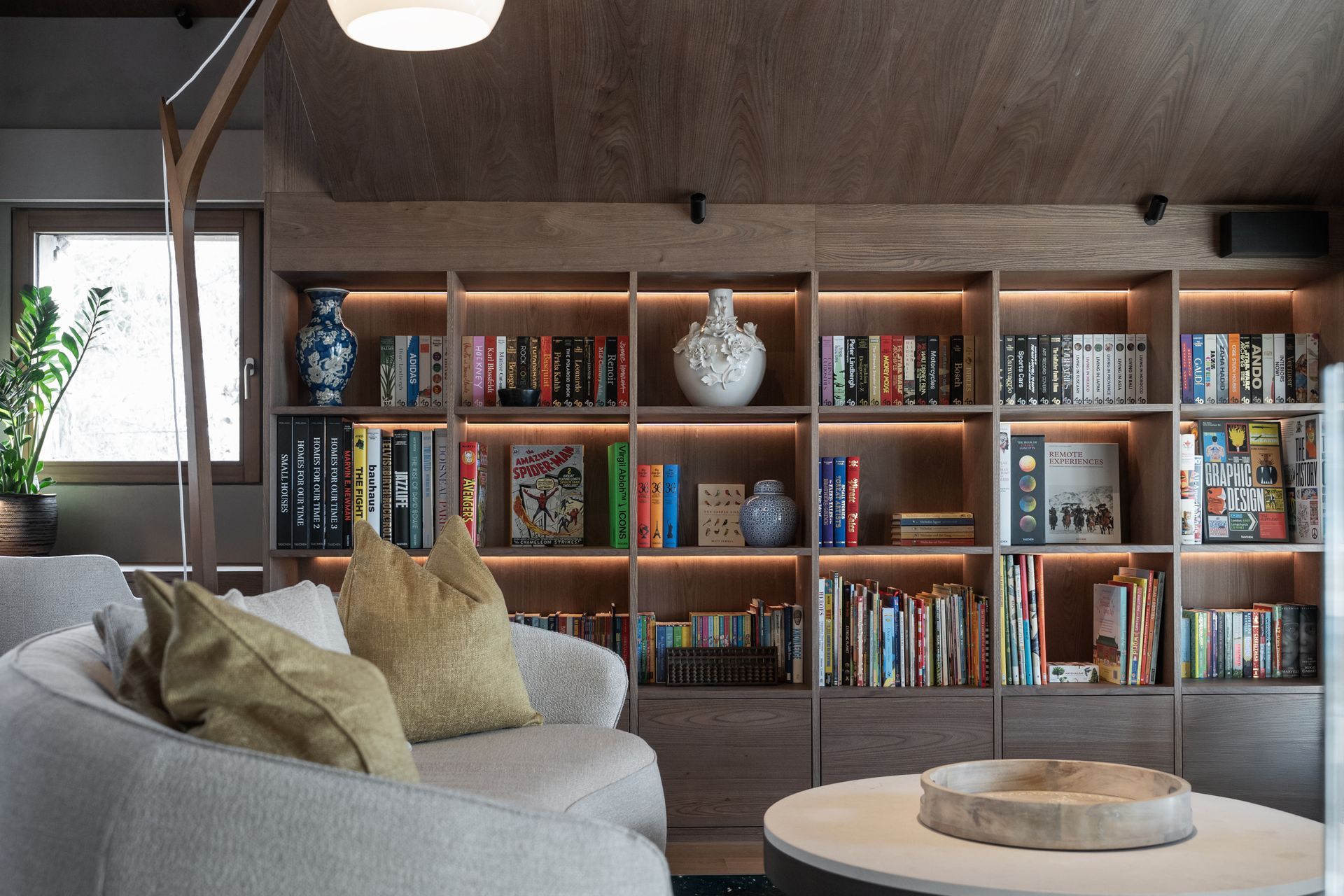 Chalet Escapade A living room filled with furniture and bookshelves.