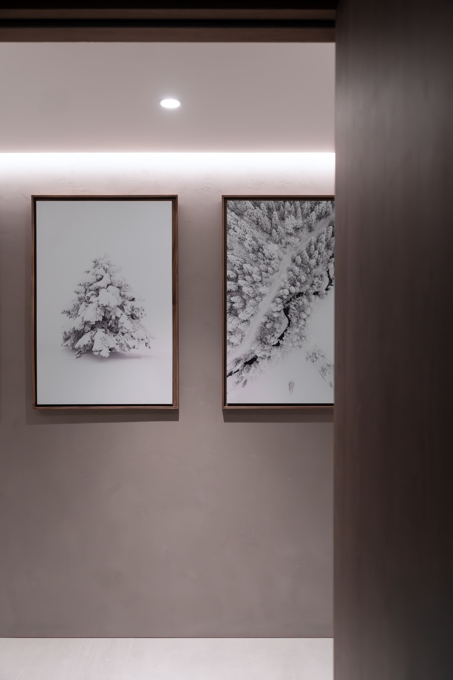 Chalet Escapade Two paintings are hanging on a wall in a hallway.