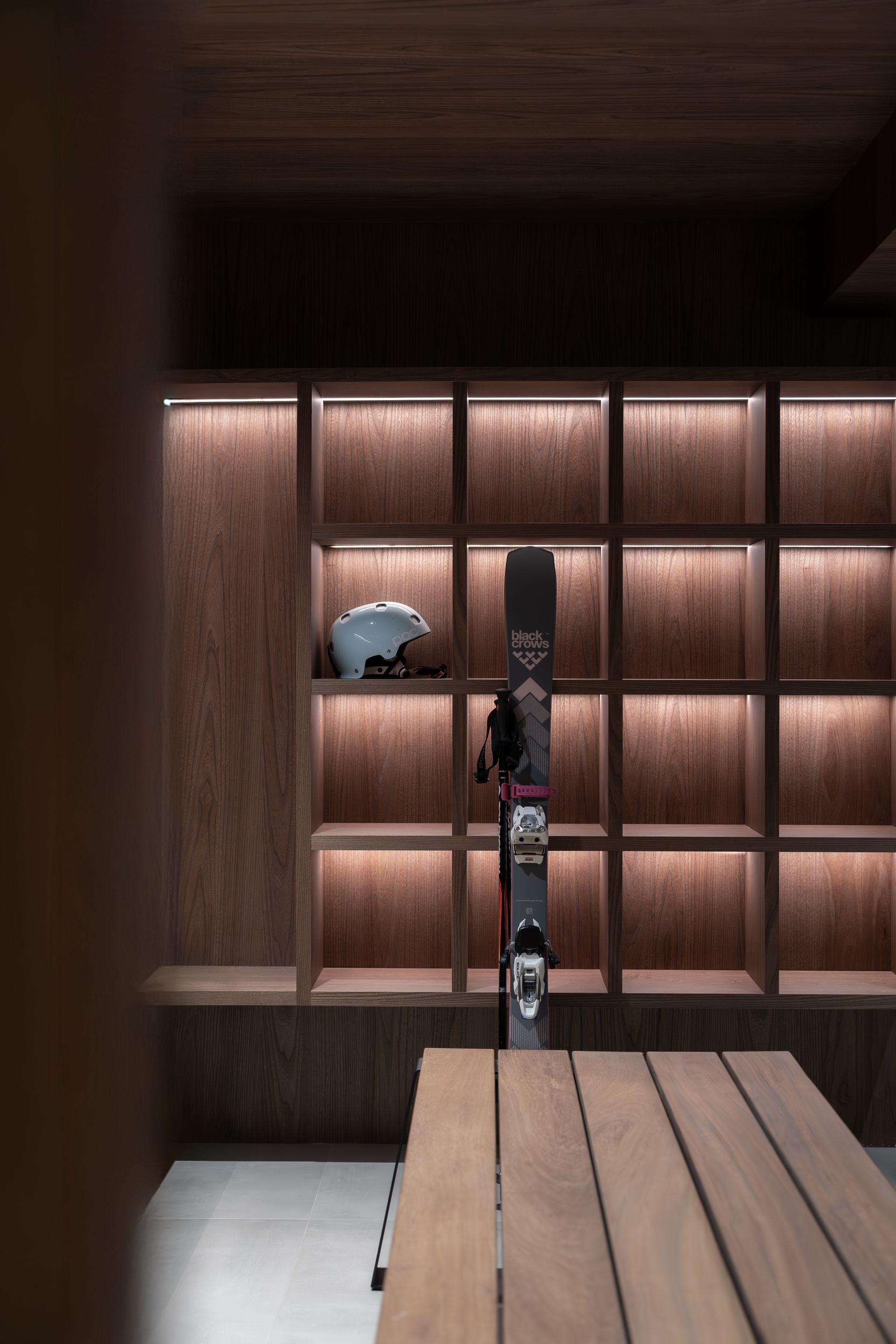 Chalet Escapade A snowboard is leaning against a wall next to a table.