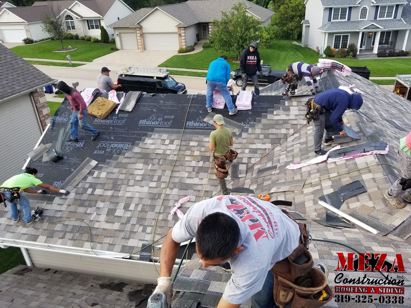 Contractors Working on Roofing Shingles | Iowa City, IA | Meza Construction Inc.
