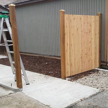 A wooden fence is being built in front of a building.