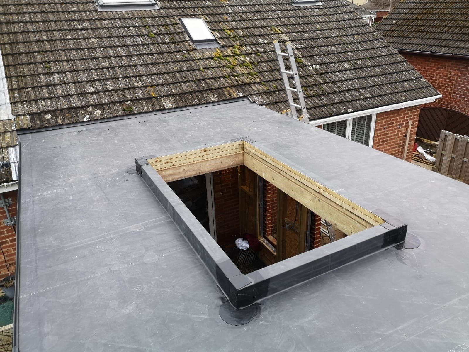 a roof with a window and a ladder on it