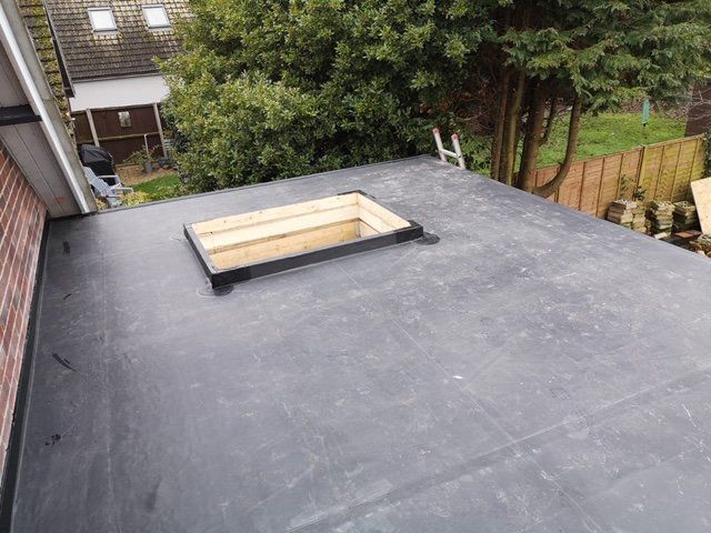 a black roof with a skylight in the middle of it .