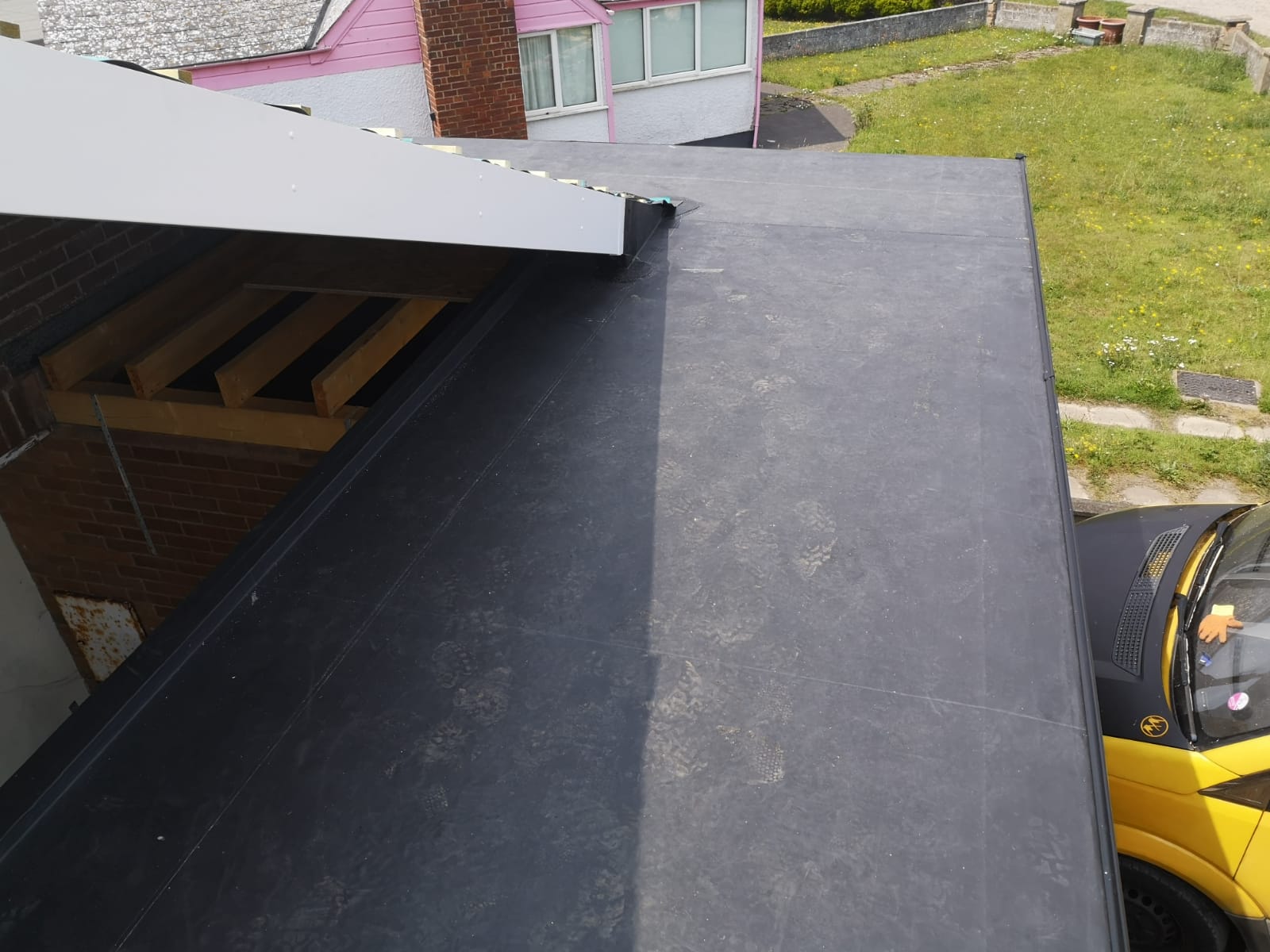 a yellow van is parked on the roof of a house