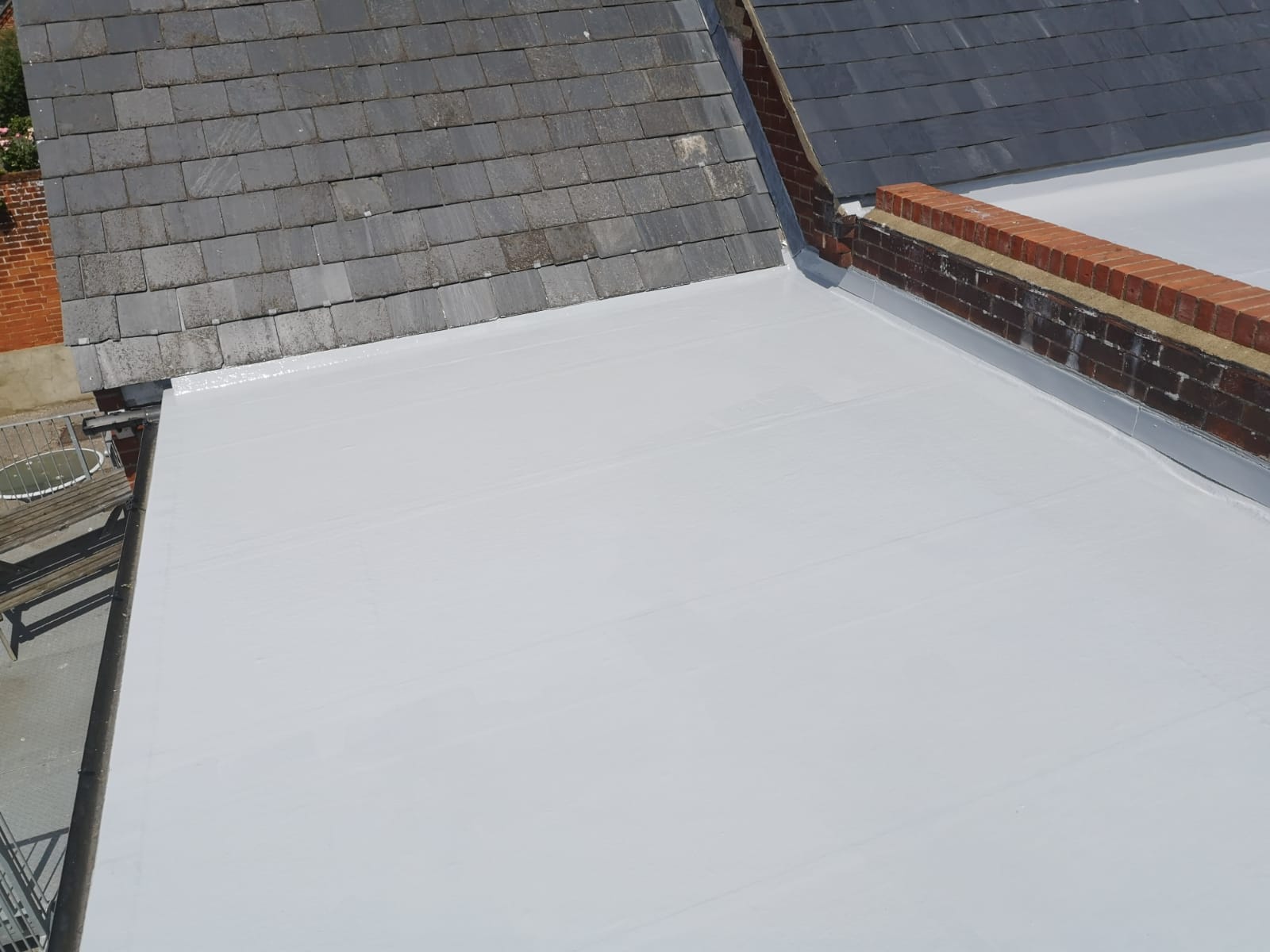 a white roof with a brick wall behind it