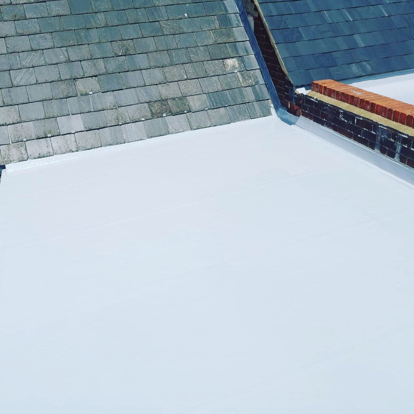 a roof with slate tiles and a white roof