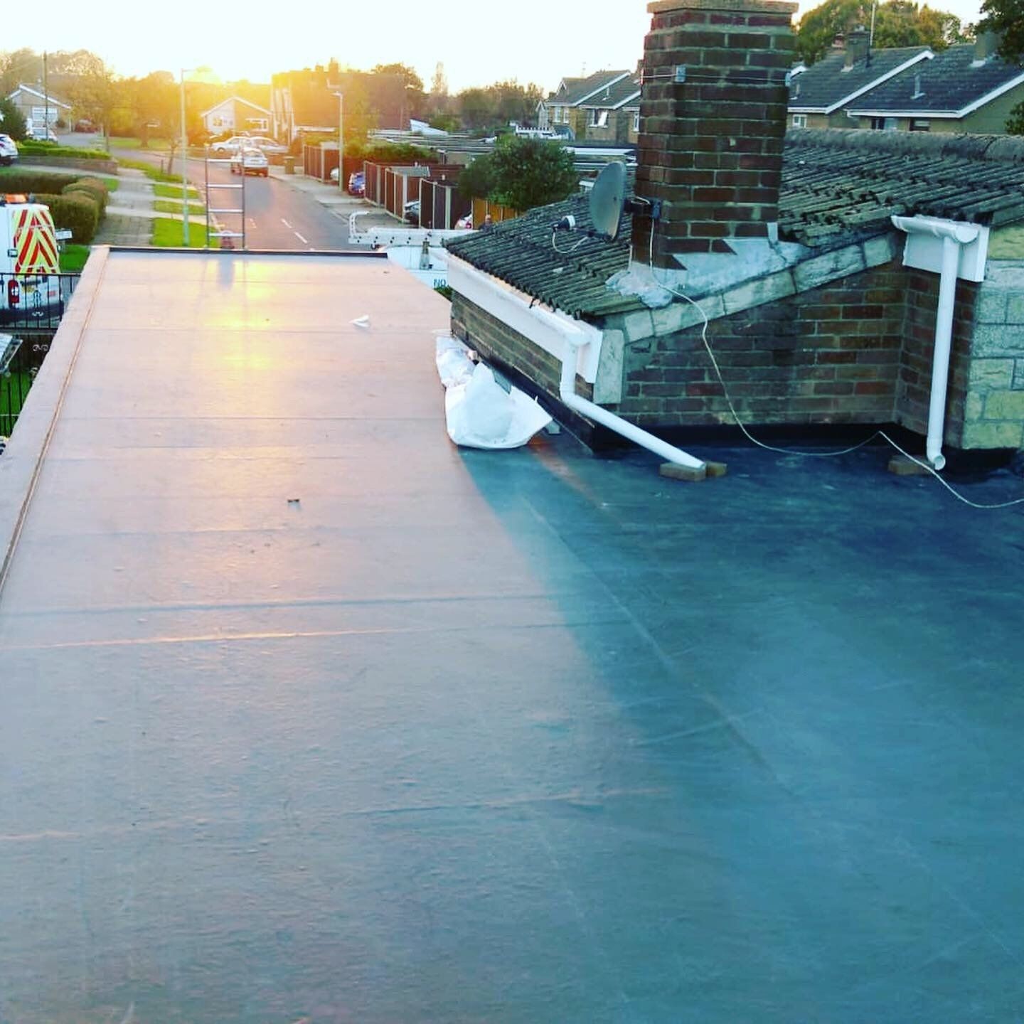 a roof with a chimney and a satellite dish on it