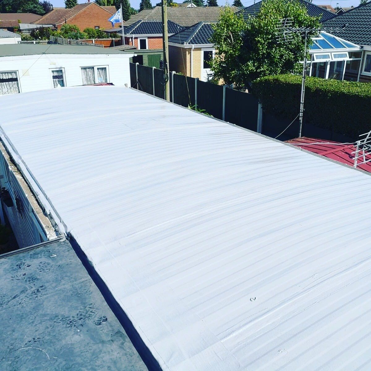 a white roof with a few houses in the background