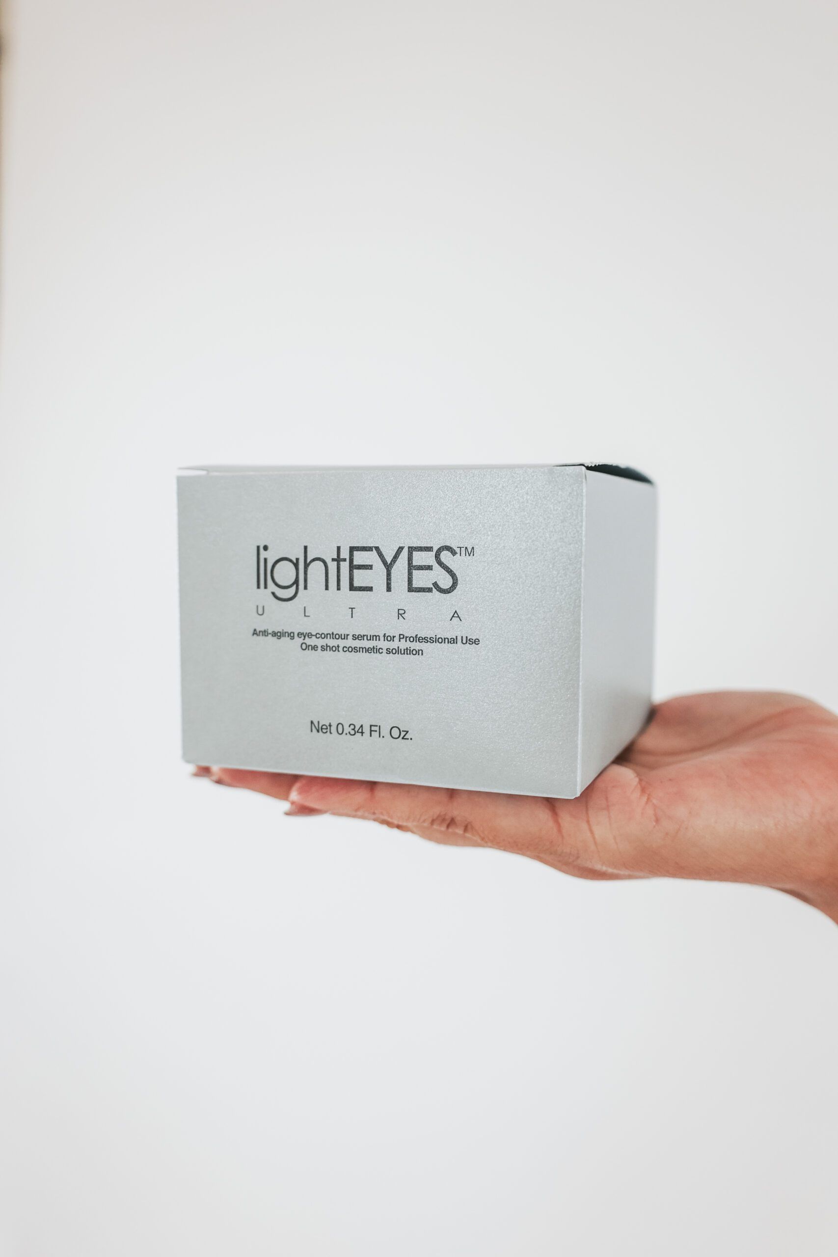 A person is holding a box of eye patches in their hand.