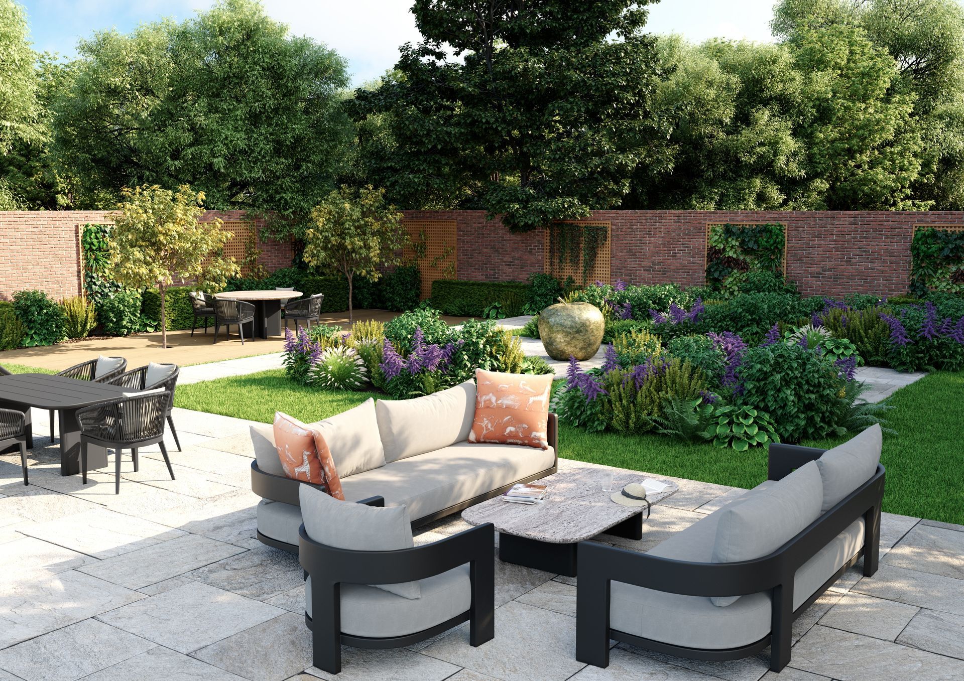 A patio seating area with a sofa, chairs, and table set on stone pavers, with a lush garden and brick wall in the background.