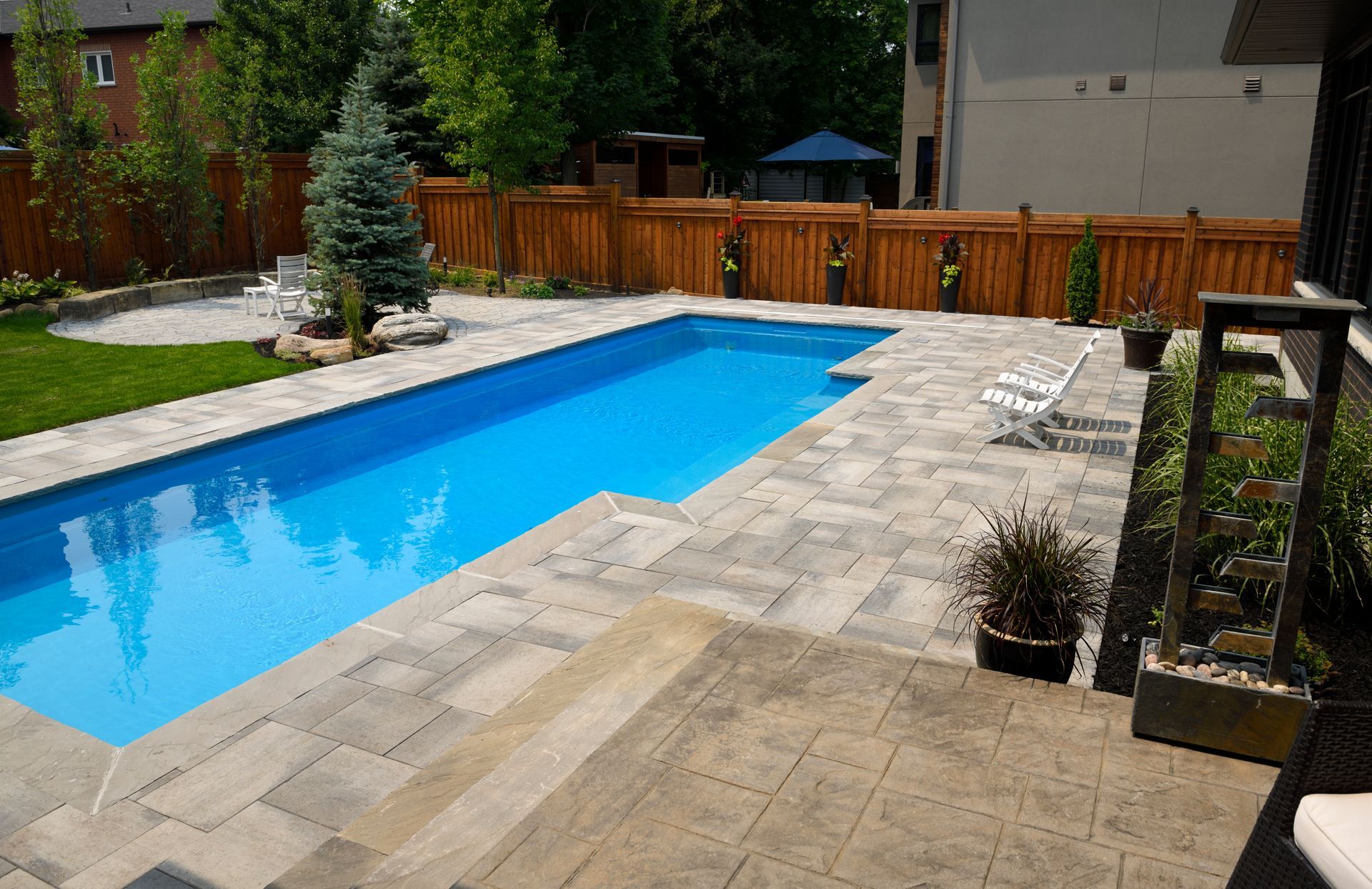 A large swimming pool in the backyard of a house