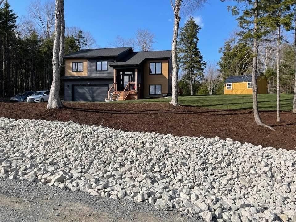 a large house is surrounded by gravel and trees