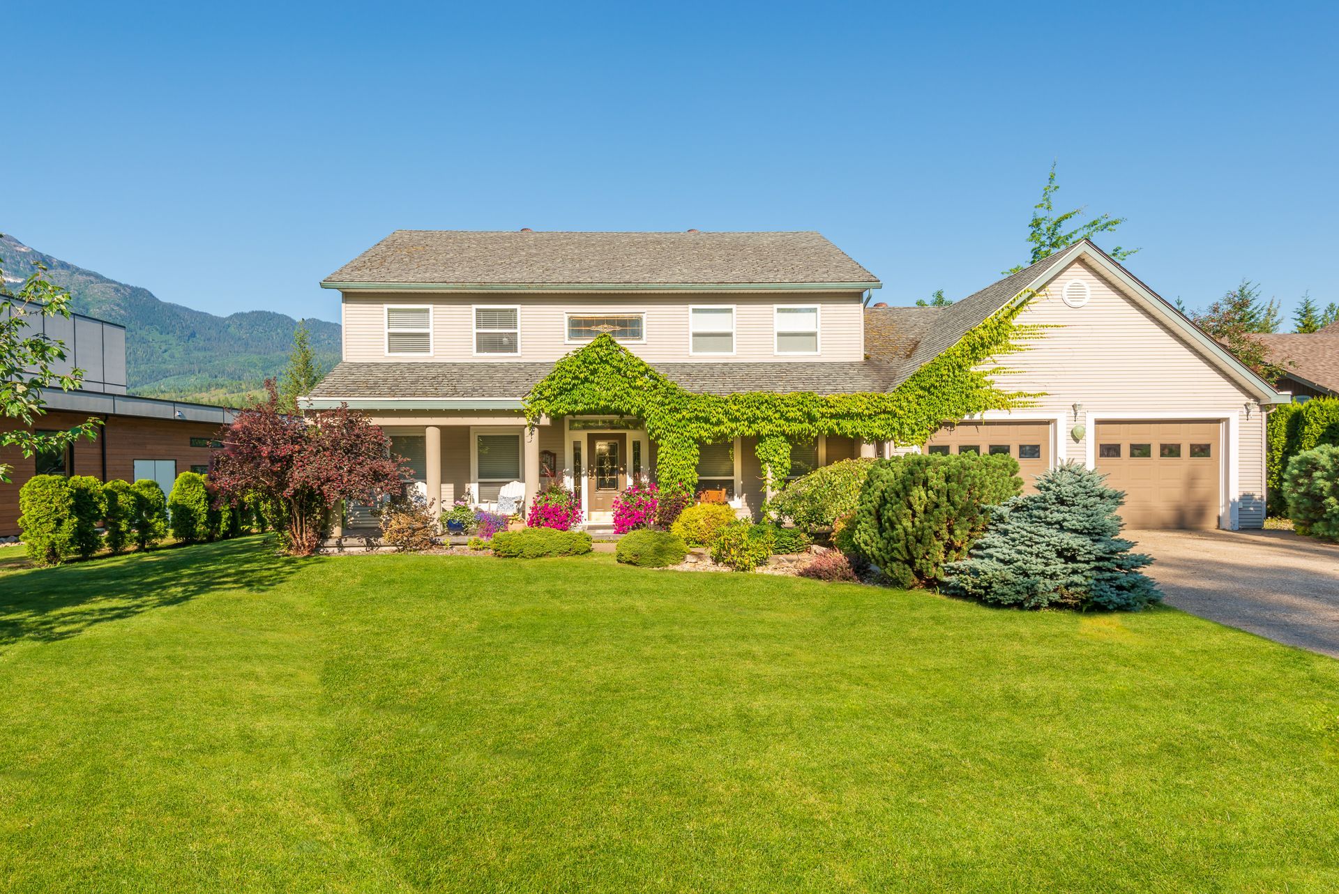 A large house with a lush green lawn in front of it.