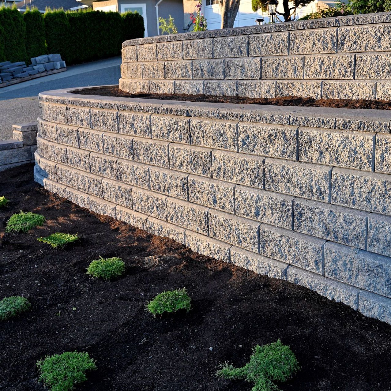 a brick wall with a planter in the middle of it