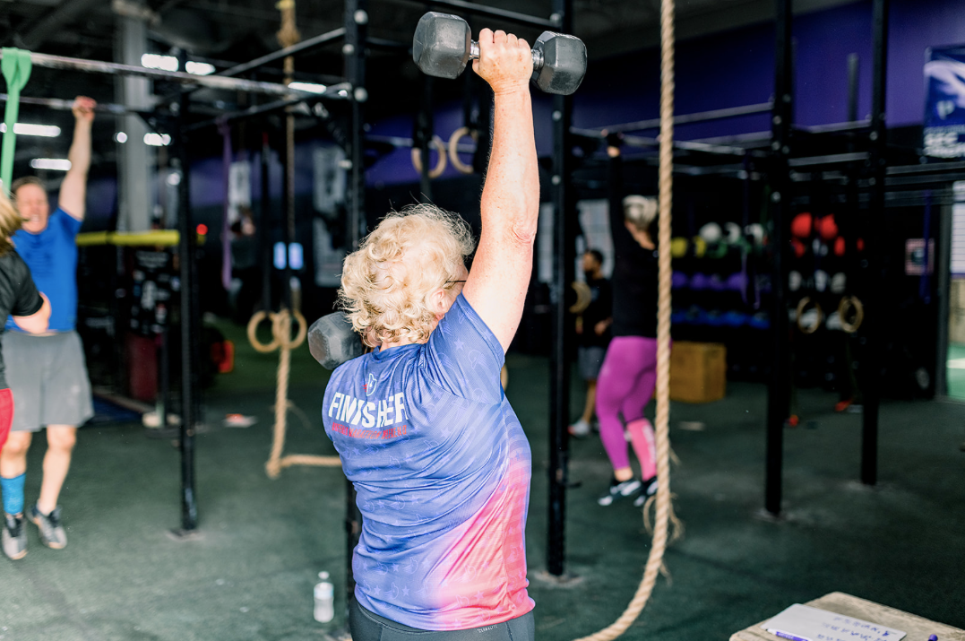 Seniors lifting weights in a 55+ class, improving strength, balance, and bone health