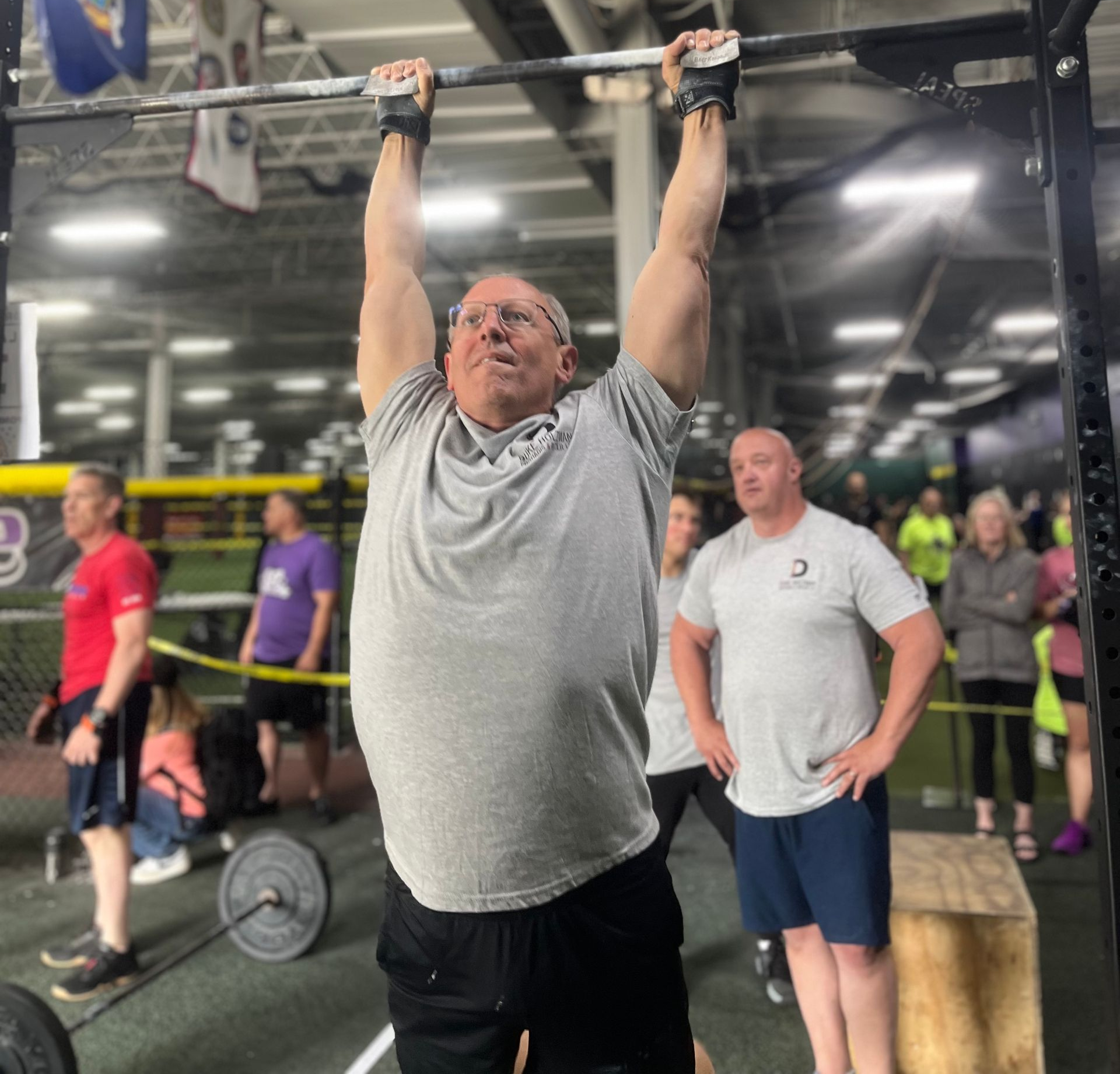 Active adults over 50 doing strength training together in supportive group fitness environment