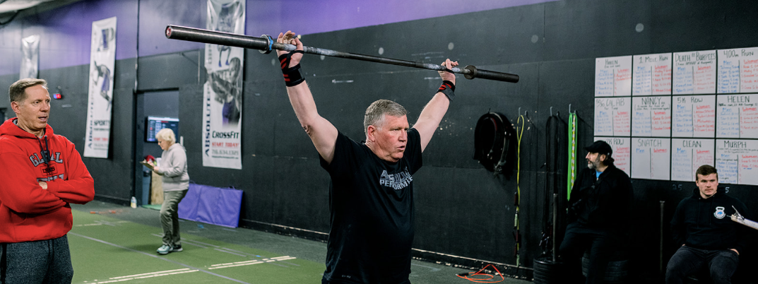 CrossFit Open athletes cheering during a workout at a CrossFit gym in Williamsville NY