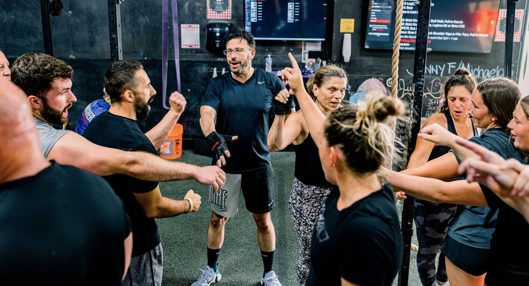 Group fitness class with all ages training together, building community and pushing through workout
