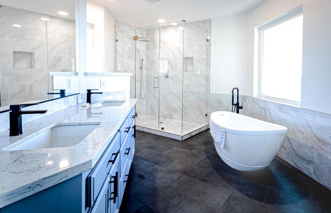 A bathroom with a tub , sink , and shower.