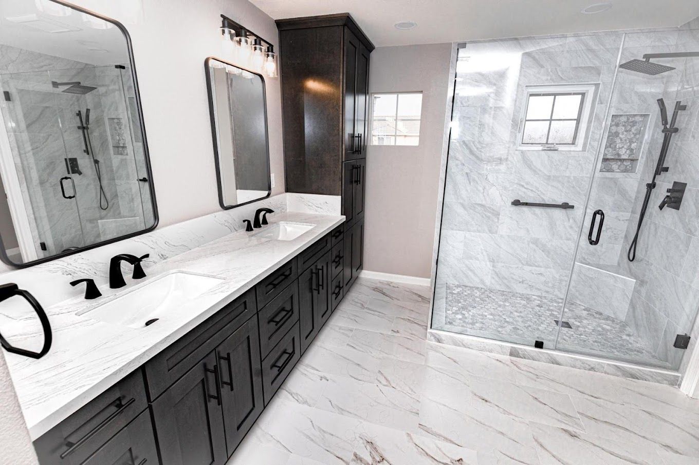 A bathroom with two sinks and a walk in shower.