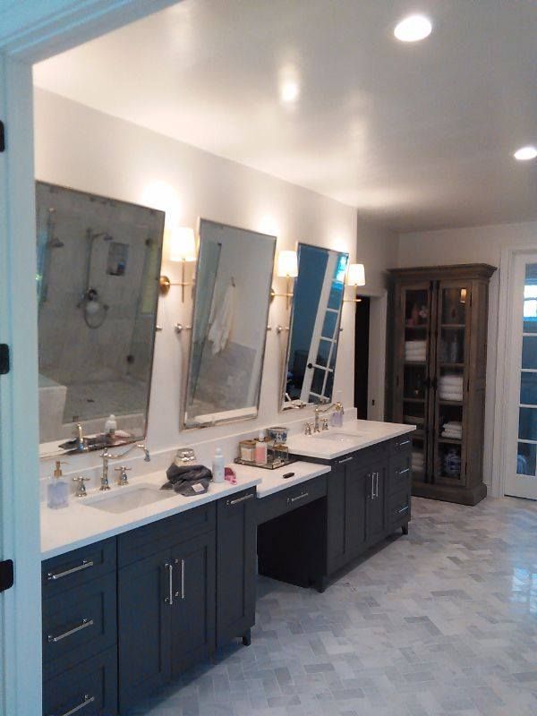 A bathroom with two sinks and two mirrors