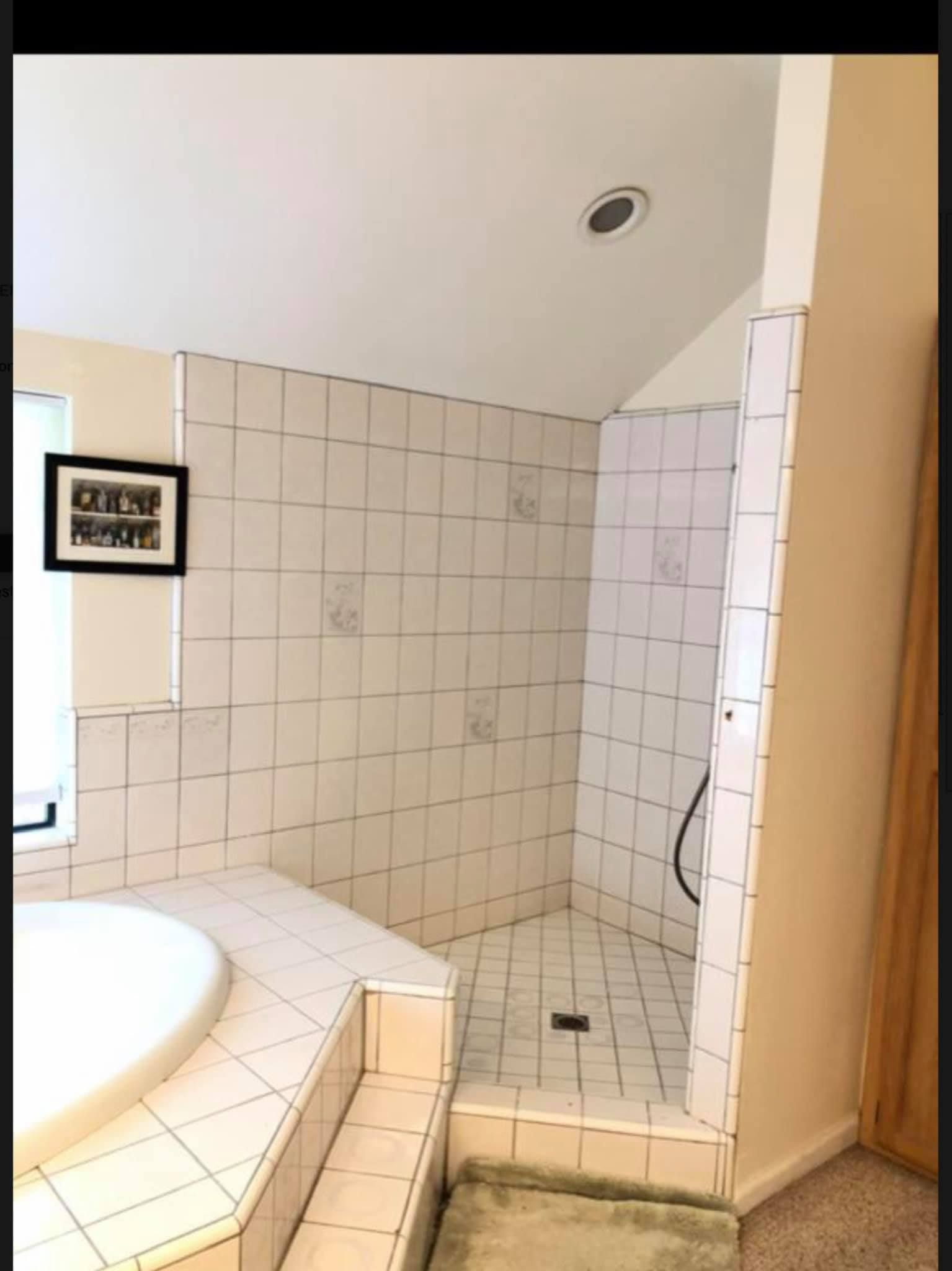A bathroom with a tub and a walk in shower.