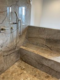 A bathroom with a bathtub and a shower.