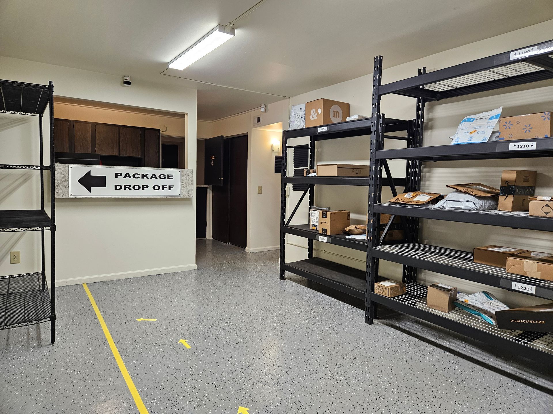 A room with a lot of shelves and boxes on them.