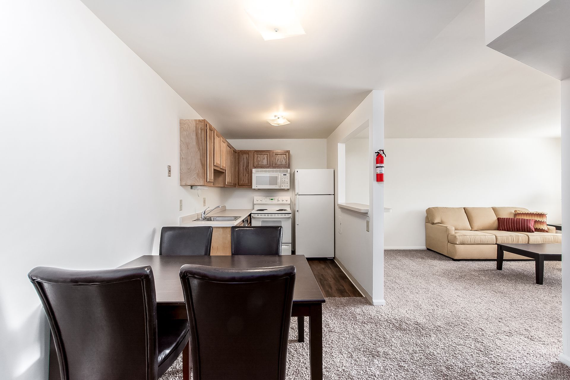 There is a dining table and chairs in the middle of the room.