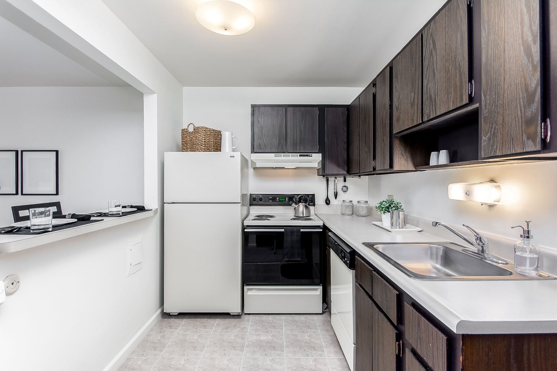 A kitchen with wooden cabinets and a white refrigerator