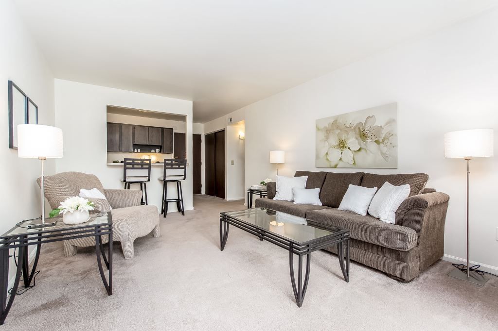 A living room with a couch a chair and a coffee table
