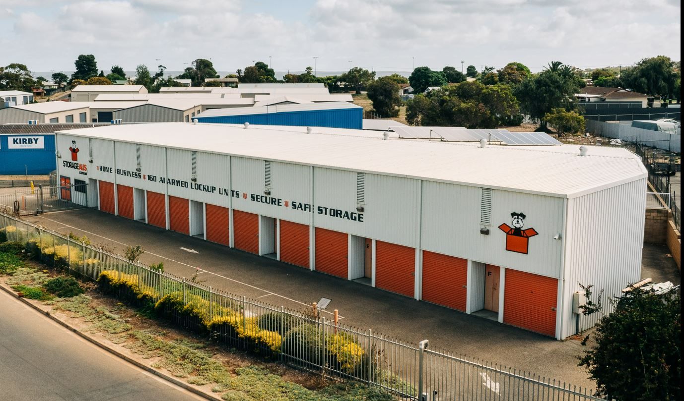 Exterior View of a Long, White Storage Facility With Orange Door — Storage Aus In Cockburn, WA