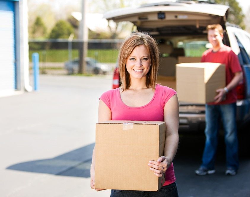 Woman Holding A Moving Box — Storage Aus In Ciccone, NT