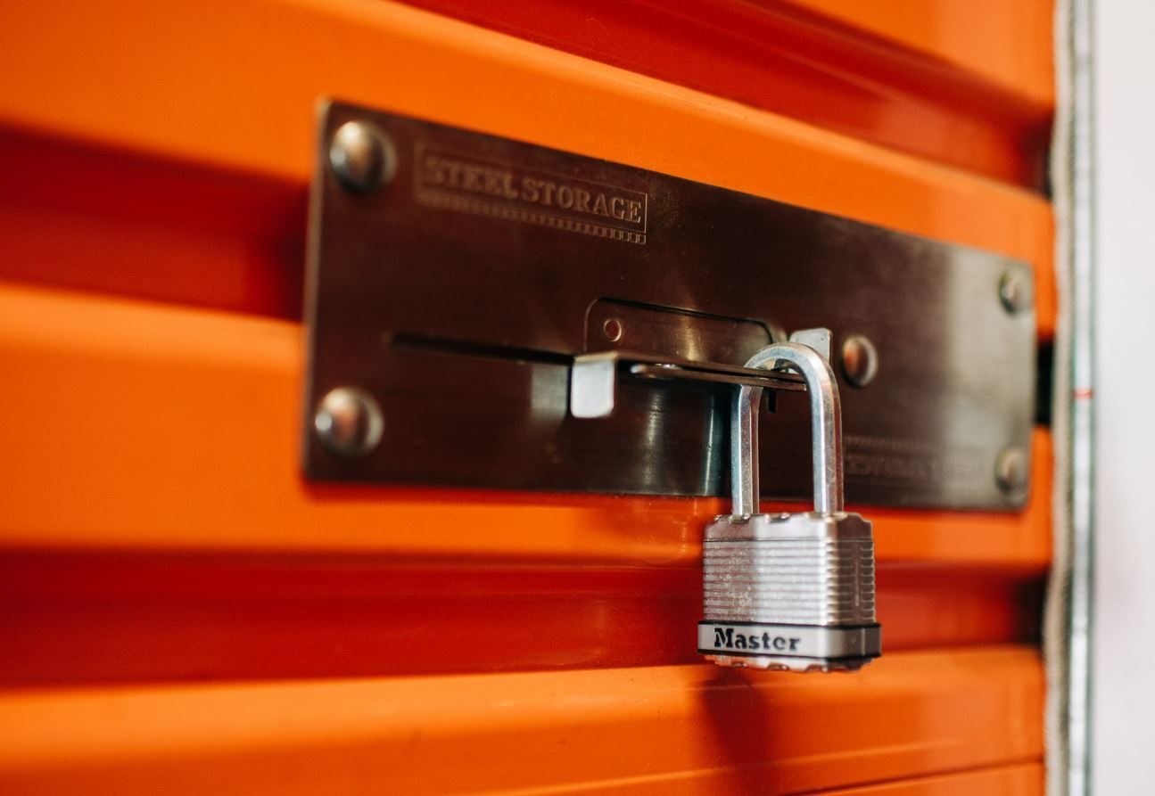 Orange Storage Unit Door With a Silver Lock — Storage Aus In Perth, WA