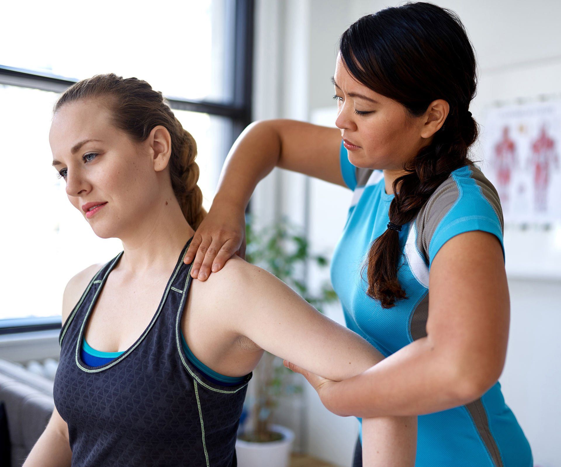 Chinese Woman Physiotherapy Professional Giving a Treatment to an Attractive Blond Client | Dapto, Nsw | Dapto Physiotherapy & Sports Injury Clinic