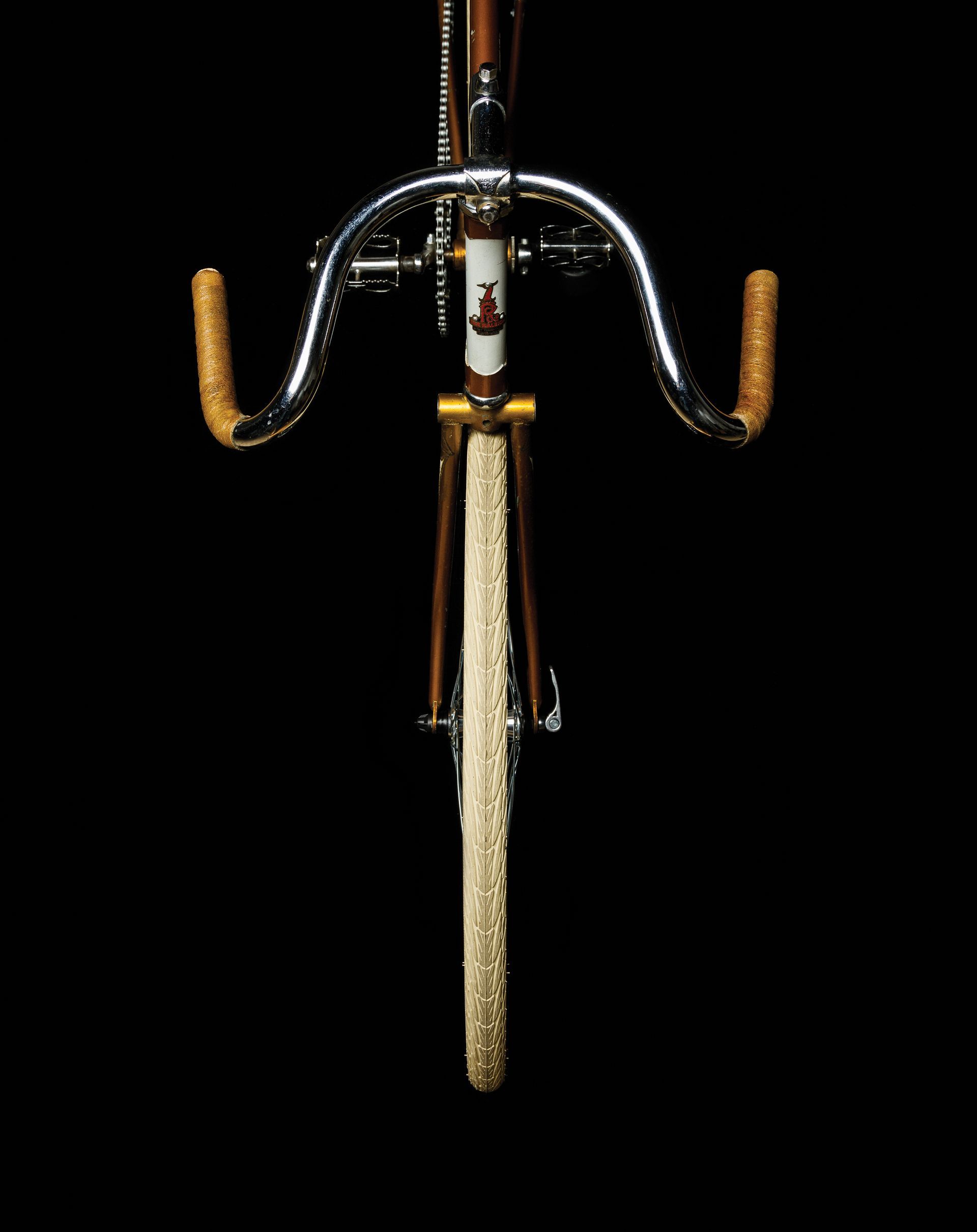 Blue bicycle with yellow accents against a black background.